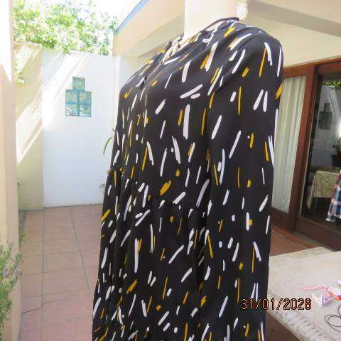Black slip over tiered dress with white-mustard print. Soft polyester. Long sleeves. Size 32-34