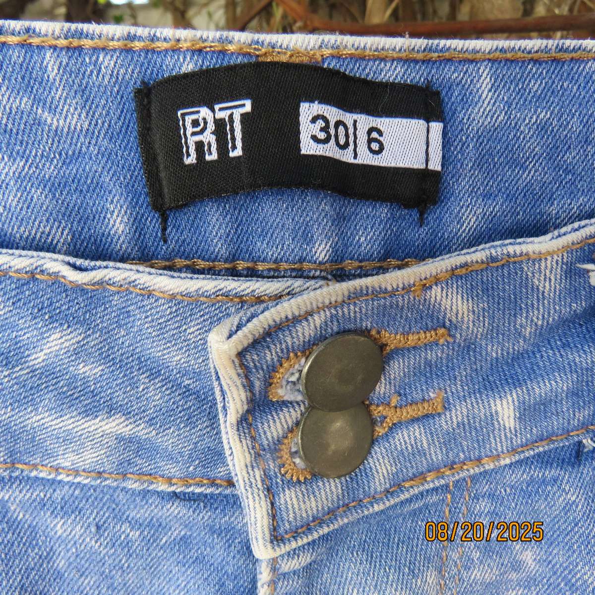 Blue denim distressed jean shorts size 30 with raw edge leg seams.