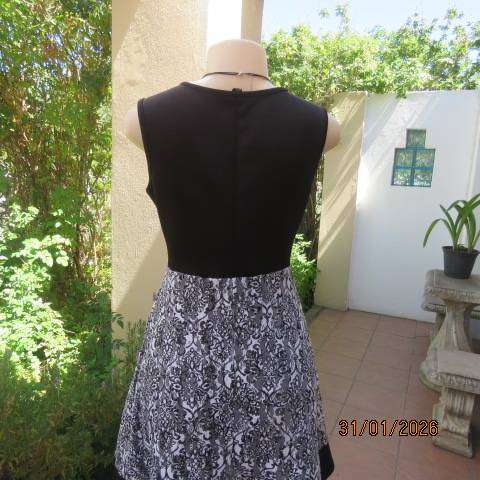 OR black stretch polyester sleeveless dress with black-white poly floral lace overlay. Size 32