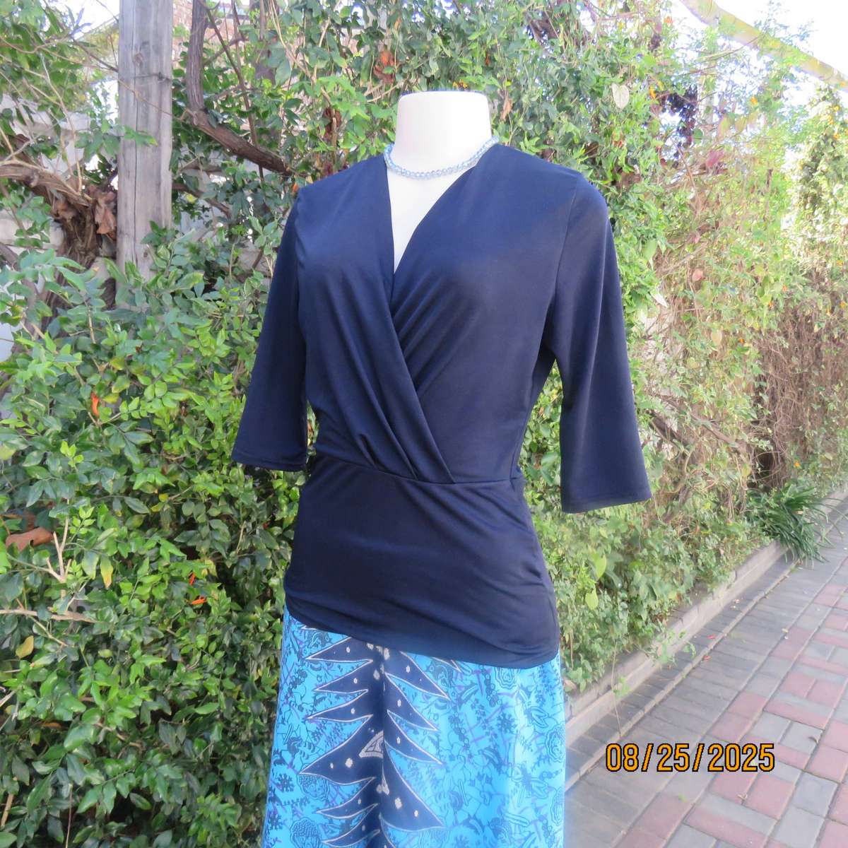 Navy stretch polyester peplum slip over top size 34. cross over bust.