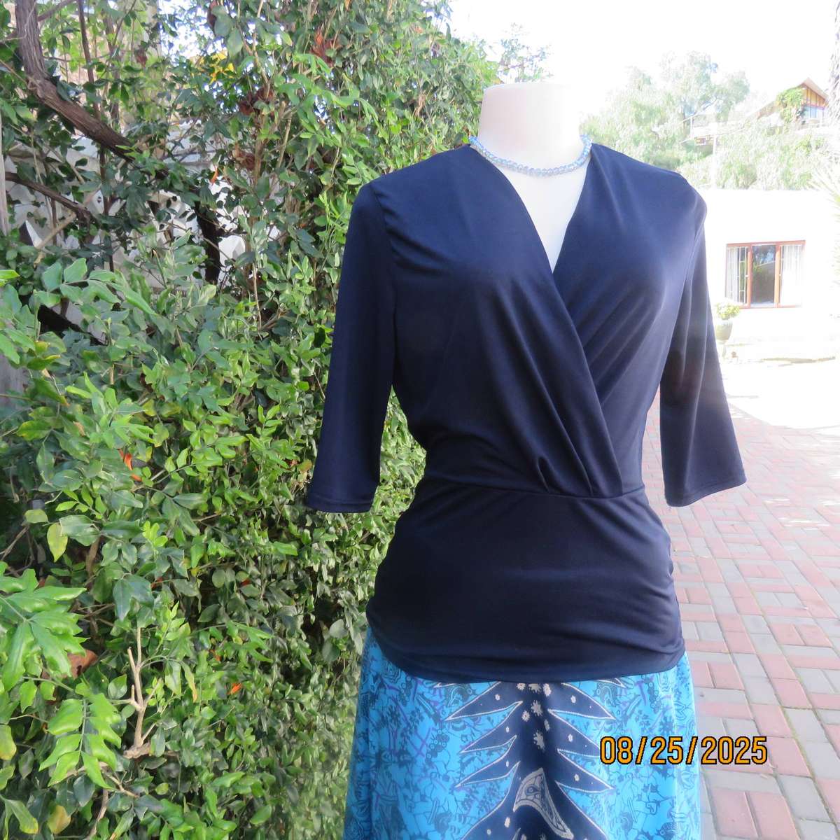 Navy stretch polyester peplum slip over top size 34. cross over bust.
