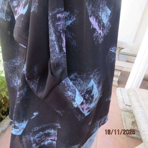 Black long cuffed sleeve polyester top with violet-blue graphic patches. Size 44-46