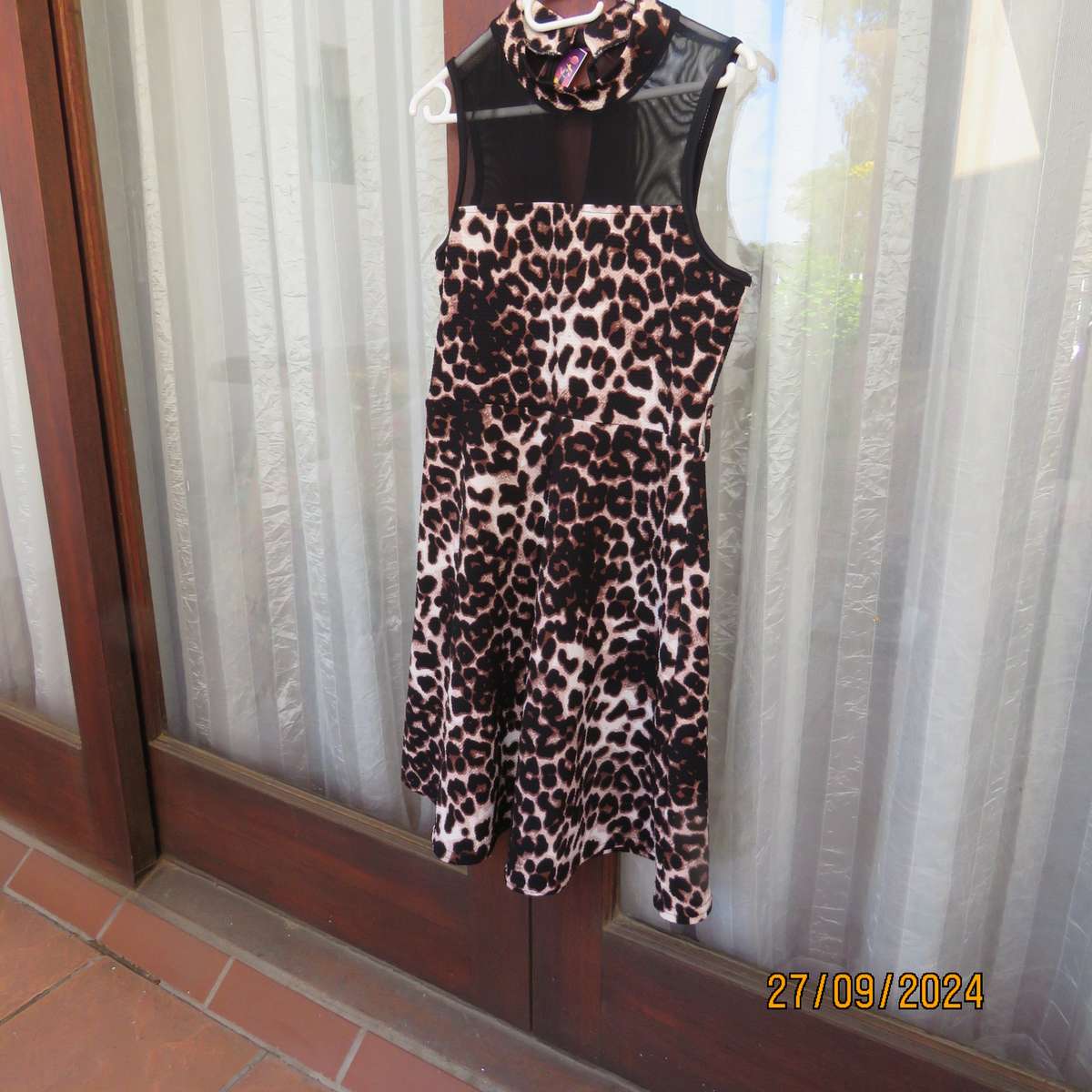 Pretty animal print textured stretch polyester dress with sheer black top area. Girl 9 to 10 years.