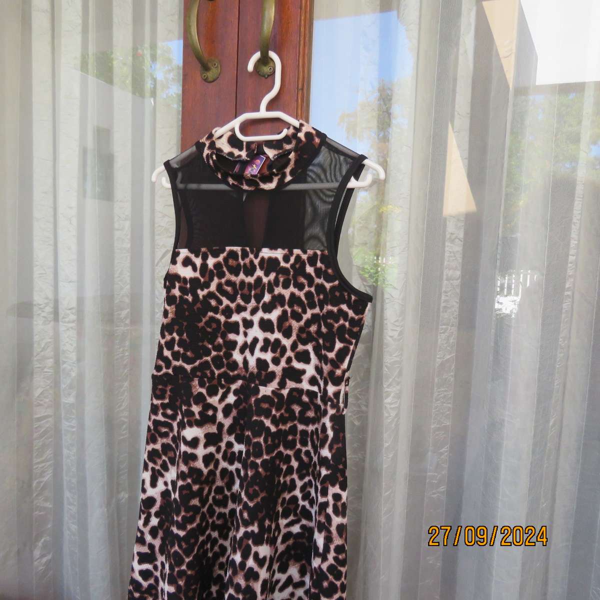 Pretty animal print textured stretch polyester dress with sheer black top area. Girl 9 to 10 years.