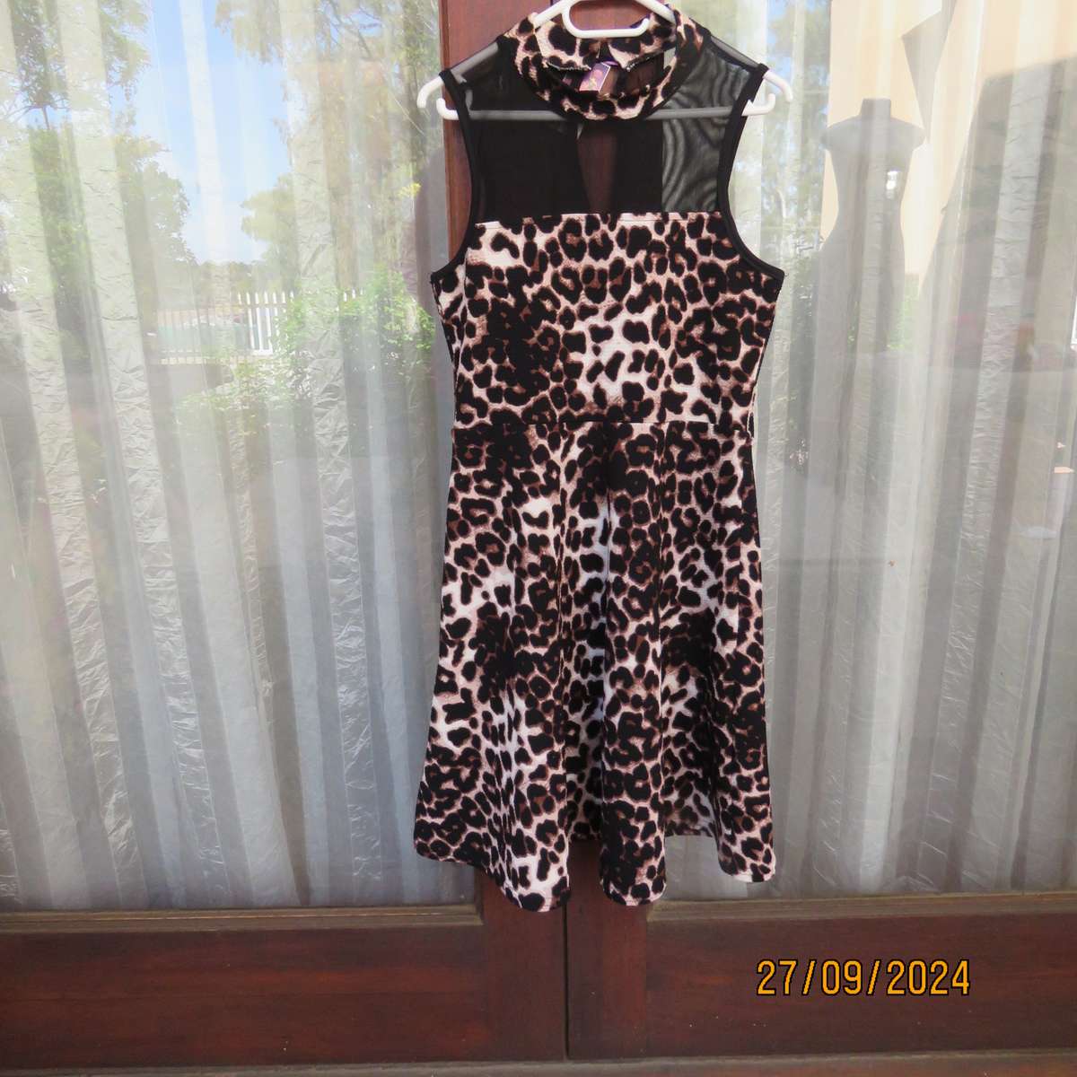 Pretty animal print textured stretch polyester dress with sheer black top area. Girl 9 to 10 years.