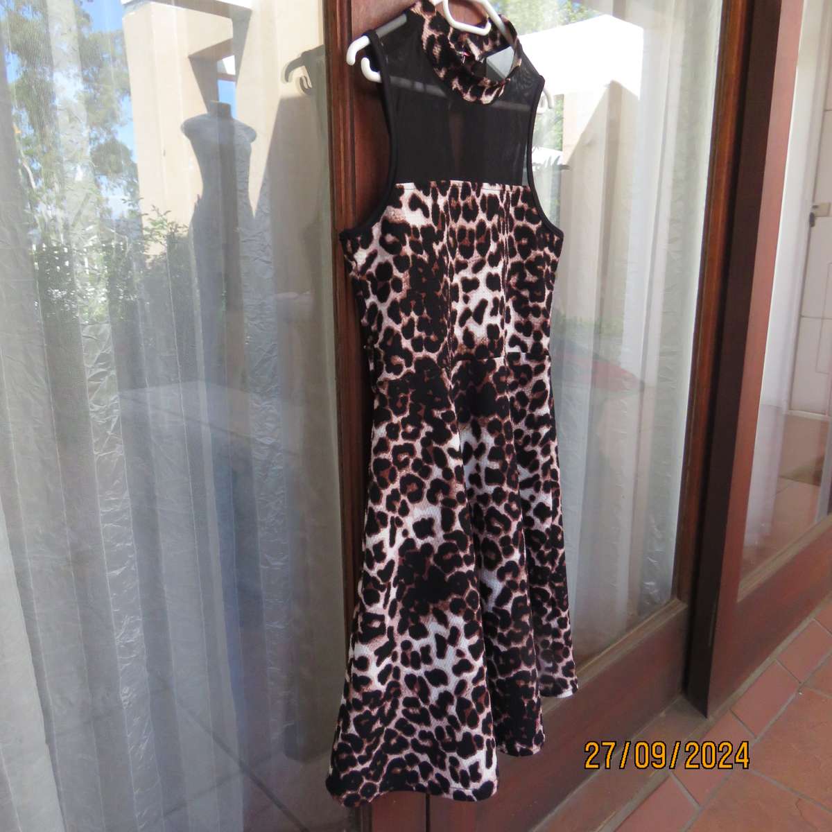 Pretty animal print textured stretch polyester dress with sheer black top area. Girl 9 to 10 years.