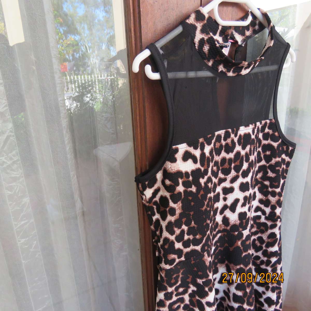 Pretty animal print textured stretch polyester dress with sheer black top area. Girl 9 to 10 years.