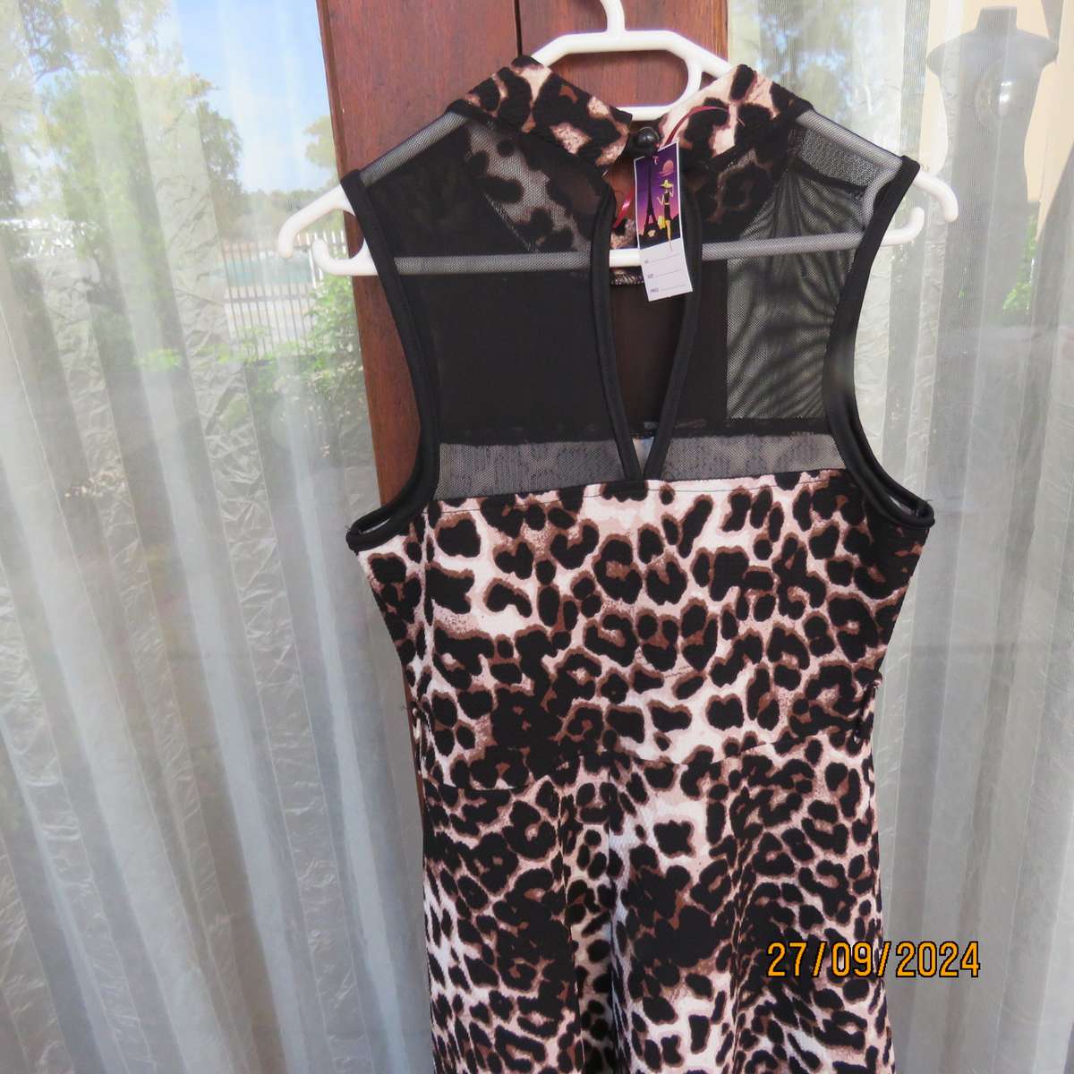 Pretty animal print textured stretch polyester dress with sheer black top area. Girl 9 to 10 years.