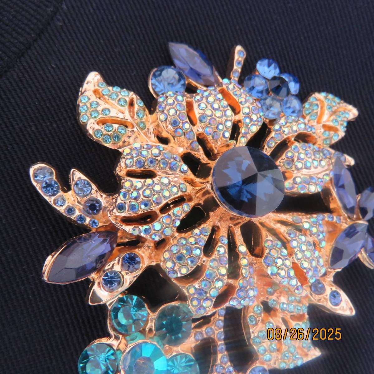 Blue stone on golden base very large brooch-decoration. 6 different stones. New