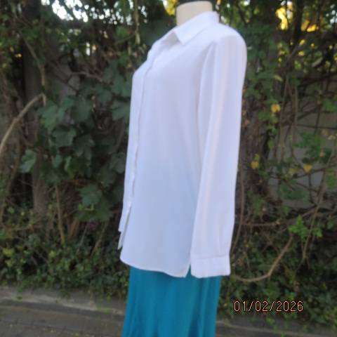 White high quality long sleeve textured polyester blouse button down .Front embroidery. Size 42