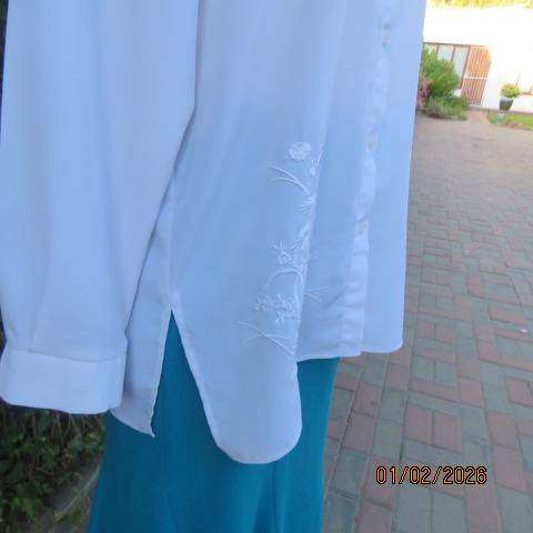 White high quality long sleeve textured polyester blouse button down .Front embroidery. Size 42