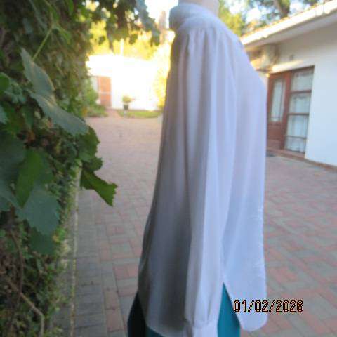 White high quality long sleeve textured polyester blouse button down .Front embroidery. Size 42
