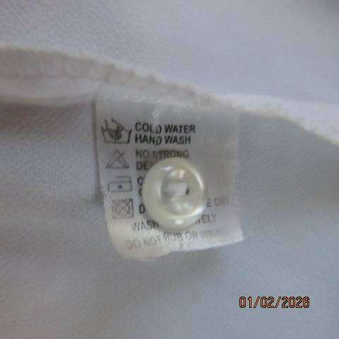 White high quality long sleeve textured polyester blouse button down .Front embroidery. Size 42