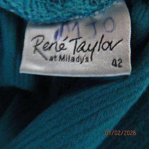 RENE TAYLOR jade skirt with asymmetrical seamline. Wide yoked front with panels. Size 42.