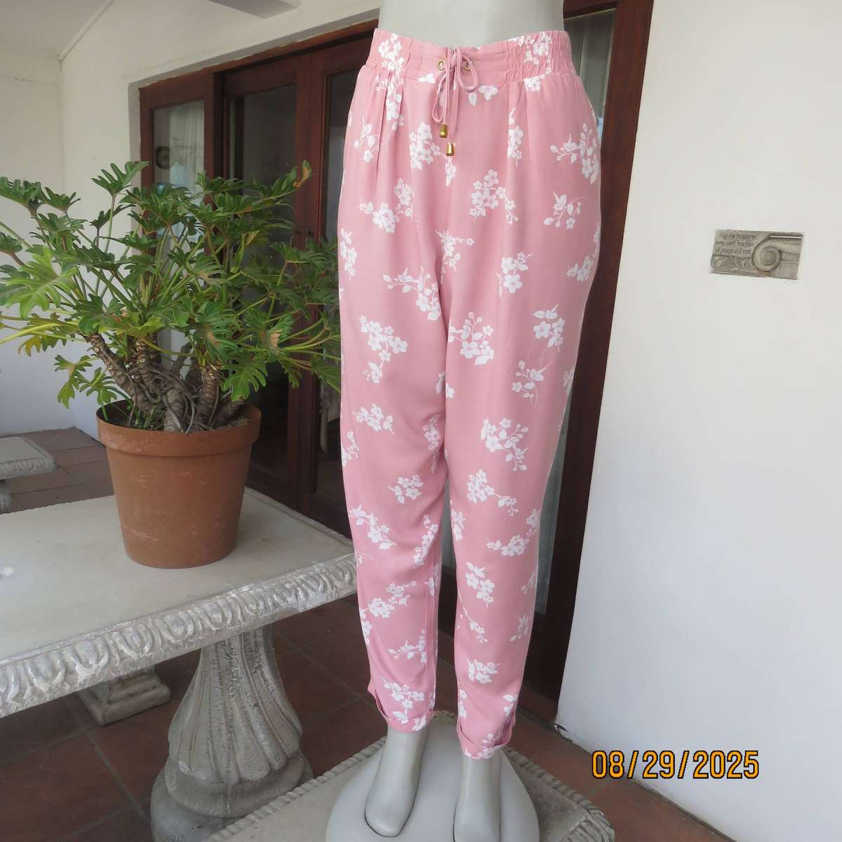 Salmon pink viscose pants with white floral pants. Elasticated waist. Size 40