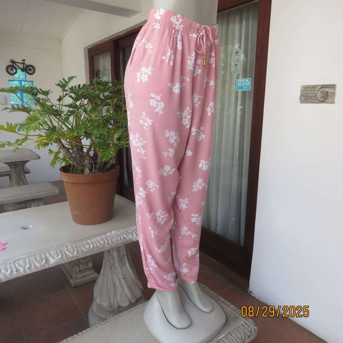 Salmon pink viscose pants with white floral pants. Elasticated waist. Size 40