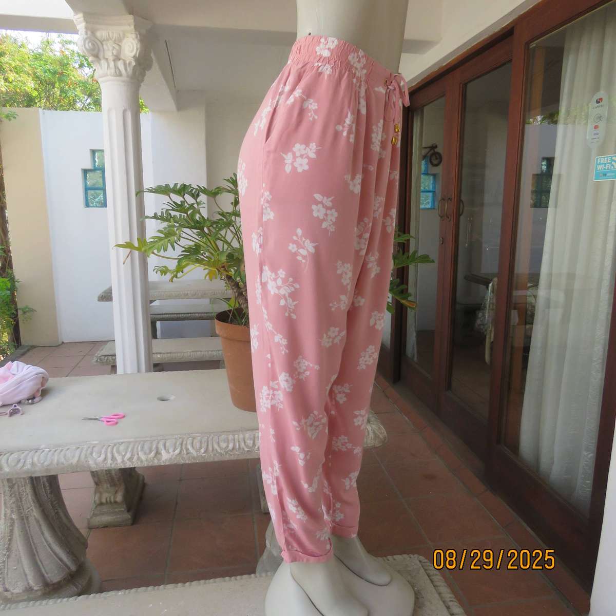 Salmon pink viscose pants with white floral pants. Elasticated waist. Size 40