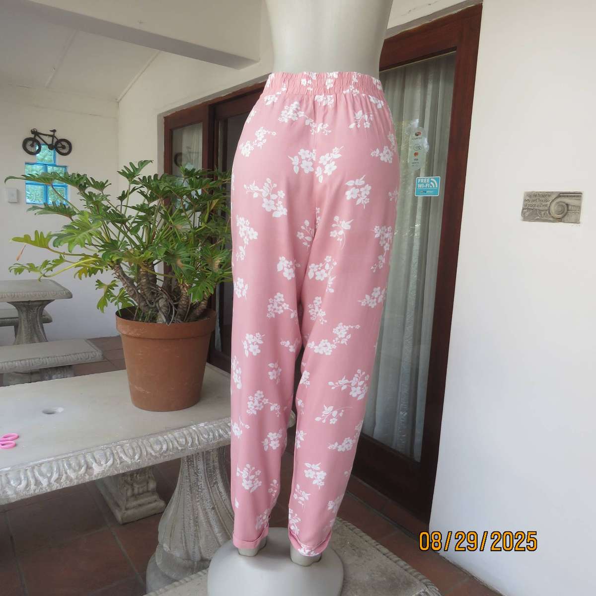 Salmon pink viscose pants with white floral pants. Elasticated waist. Size 40