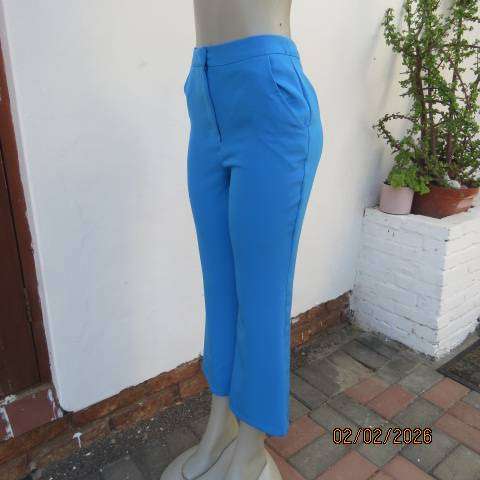 MISS L blue ankle length high waist stretch polyester bootlegged pants. Size 34