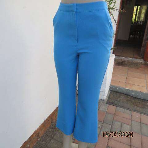 MISS L blue ankle length high waist stretch polyester bootlegged pants. Size 34