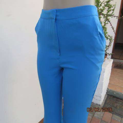 MISS L blue ankle length high waist stretch polyester bootlegged pants. Size 34