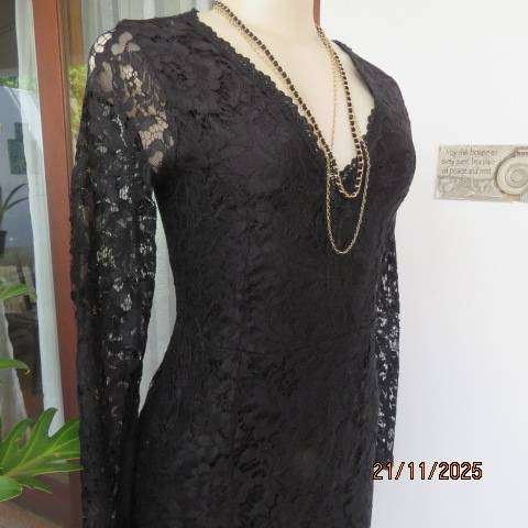 Little black long sleeve lace dress lined with stretch polyester. V neck. Size 32