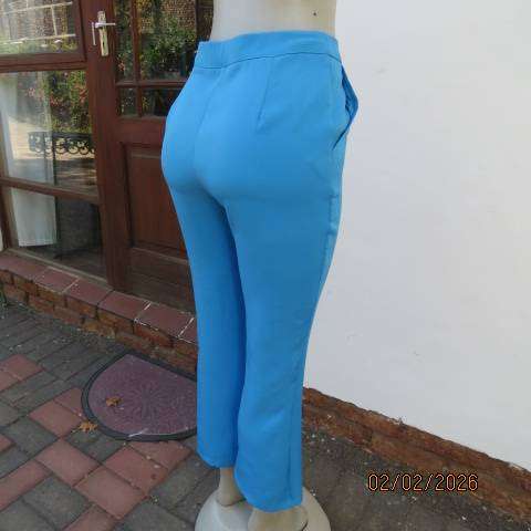 MISS L blue ankle length high waist stretch polyester bootlegged pants. Size 34
