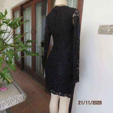 Little black long sleeve lace dress lined with stretch polyester. V neck. Size 32