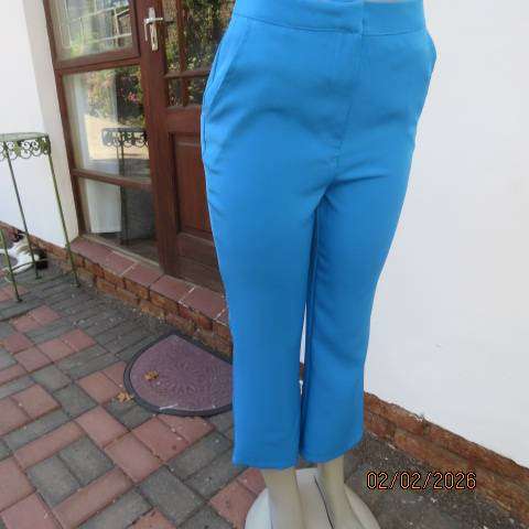 MISS L blue ankle length high waist stretch polyester bootlegged pants. Size 34