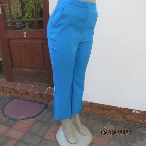 MISS L blue ankle length high waist stretch polyester bootlegged pants. Size 34