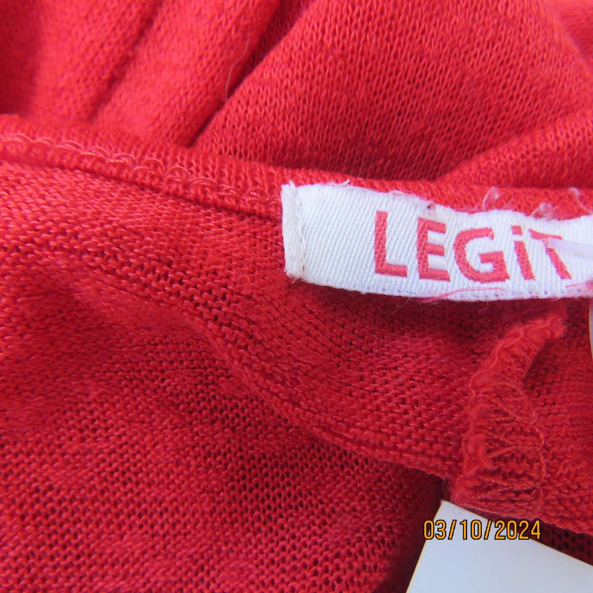 Chic bright red sleeveless top by LEGIT. Size 32. In textured stretch polyester. Longer at back.