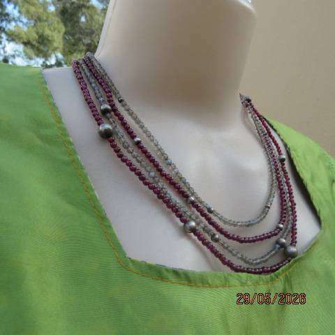 Multi-string necklace with tiny red garnets and labradorite. Floral clasp with C marking