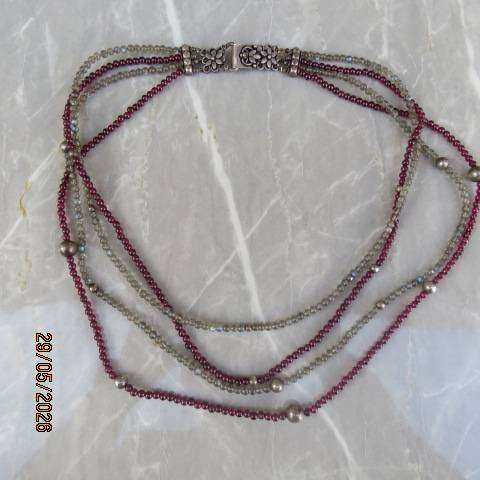 Multi-string necklace with tiny red garnets and labradorite. Floral clasp with C marking