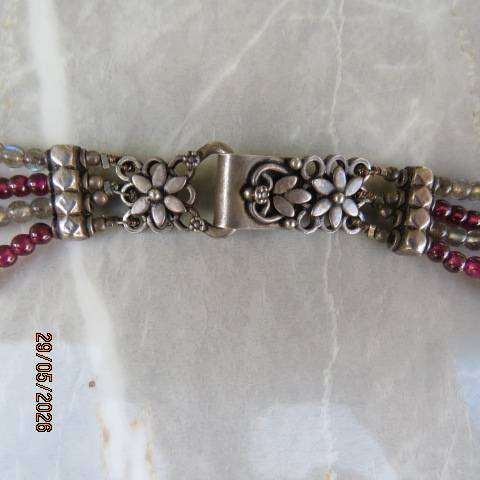 Multi-string necklace with tiny red garnets and labradorite. Floral clasp with C marking