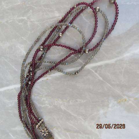 Multi-string necklace with tiny red garnets and labradorite. Floral clasp with C marking