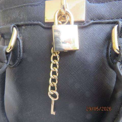 ALDO black hand-sling bag with zip-up closure and gilded lock and key. Never used