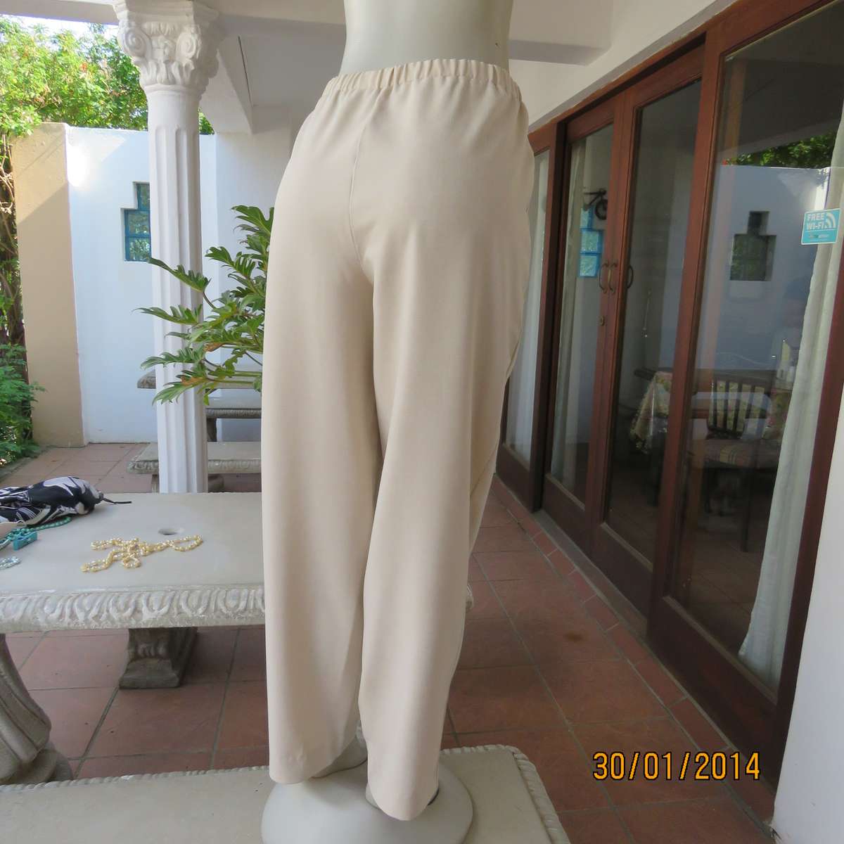 Boutique made mottled cream polyester pants.Tapered legs.Elasticated waist band.Size 40.As new