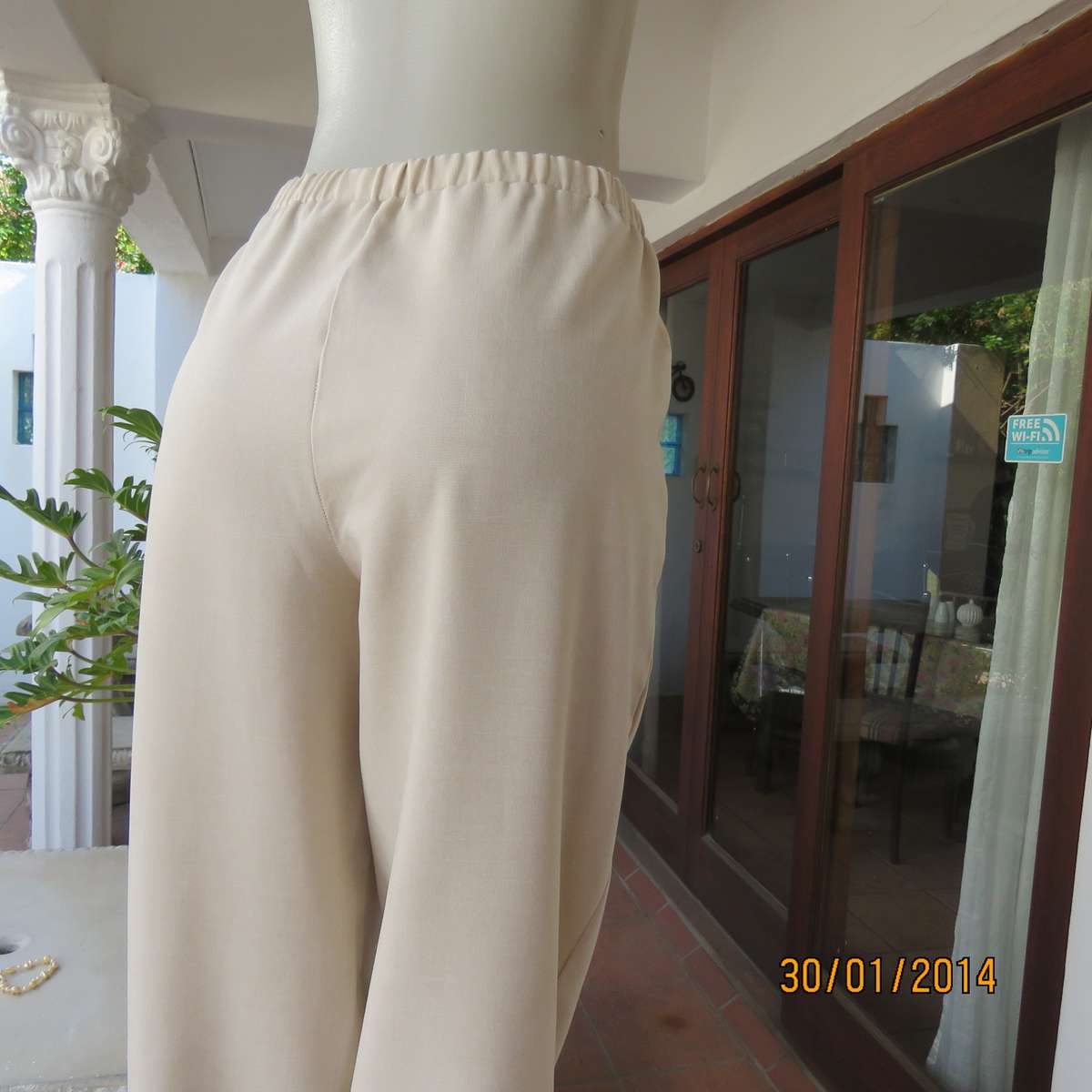 Boutique made mottled cream polyester pants.Tapered legs.Elasticated waist band.Size 40.As new