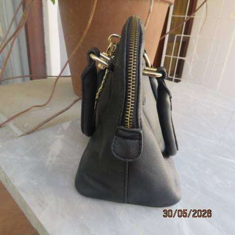 ALDO black hand-sling bag with zip-up closure and gilded lock and key. Never used