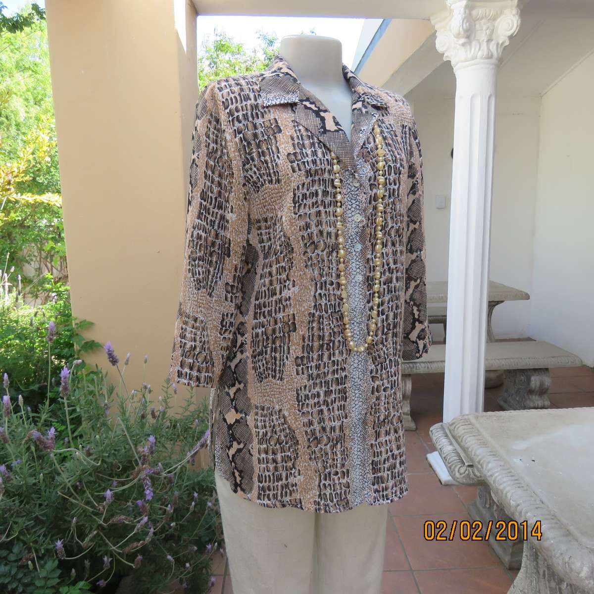 Animal print polyester top size 36. Beige-peach and black. Bracelet length sleeves.