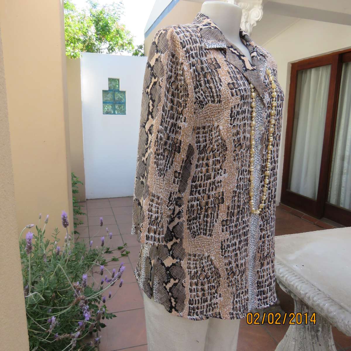 Animal print polyester top size 36. Beige-peach and black. Bracelet length sleeves.