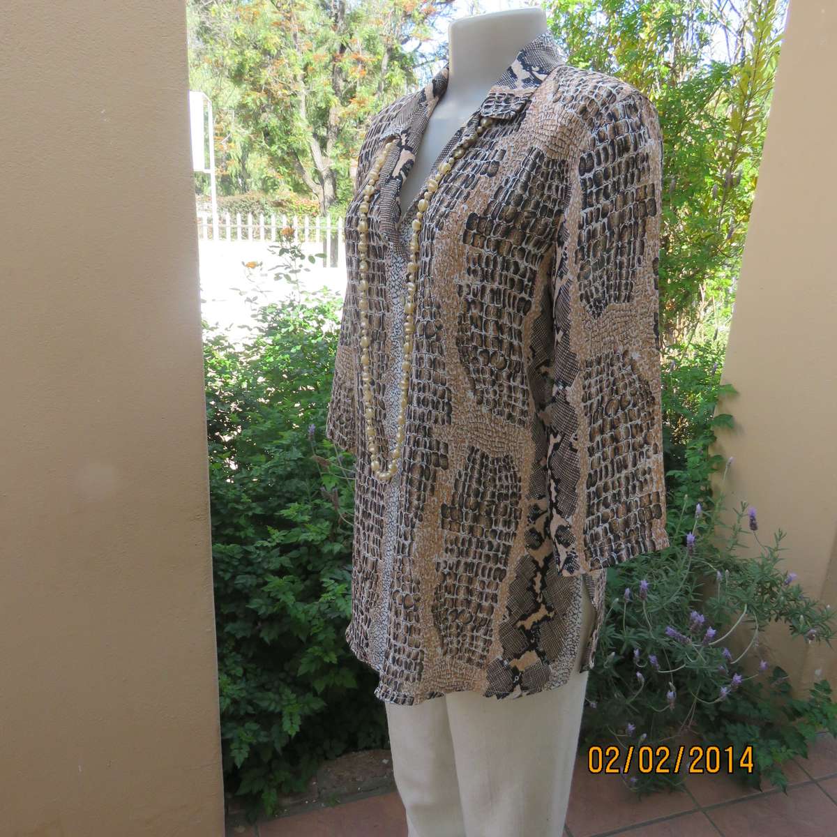 Animal print polyester top size 36. Beige-peach and black. Bracelet length sleeves.