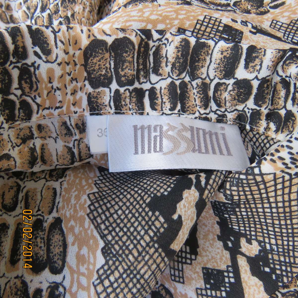 Animal print polyester top size 36. Beige-peach and black. Bracelet length sleeves.