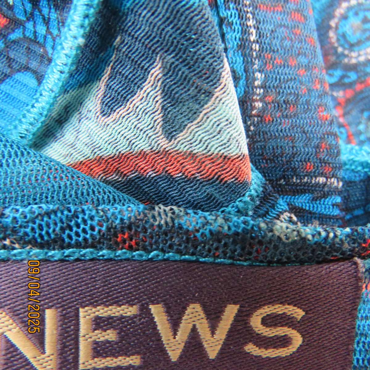 NEWS halfmoon sheer jade colour top with aqua-rust geometric print. Size 38