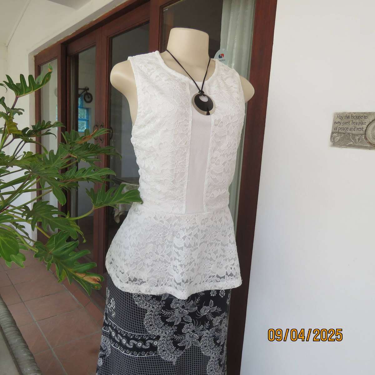 White stretch polyester lace slip over peplum top fully lined. Size 38