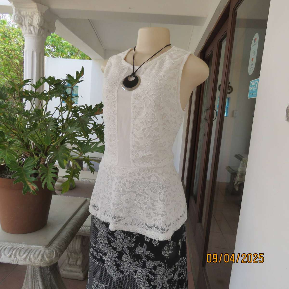 White stretch polyester lace slip over peplum top fully lined. Size 38