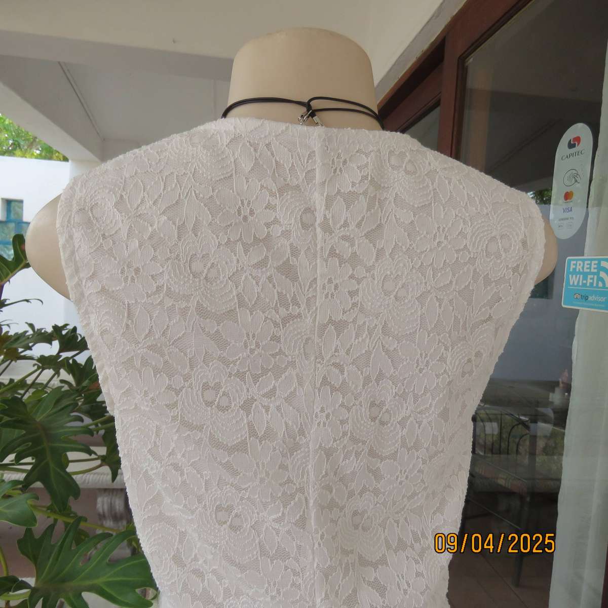White stretch polyester lace slip over peplum top fully lined. Size 38