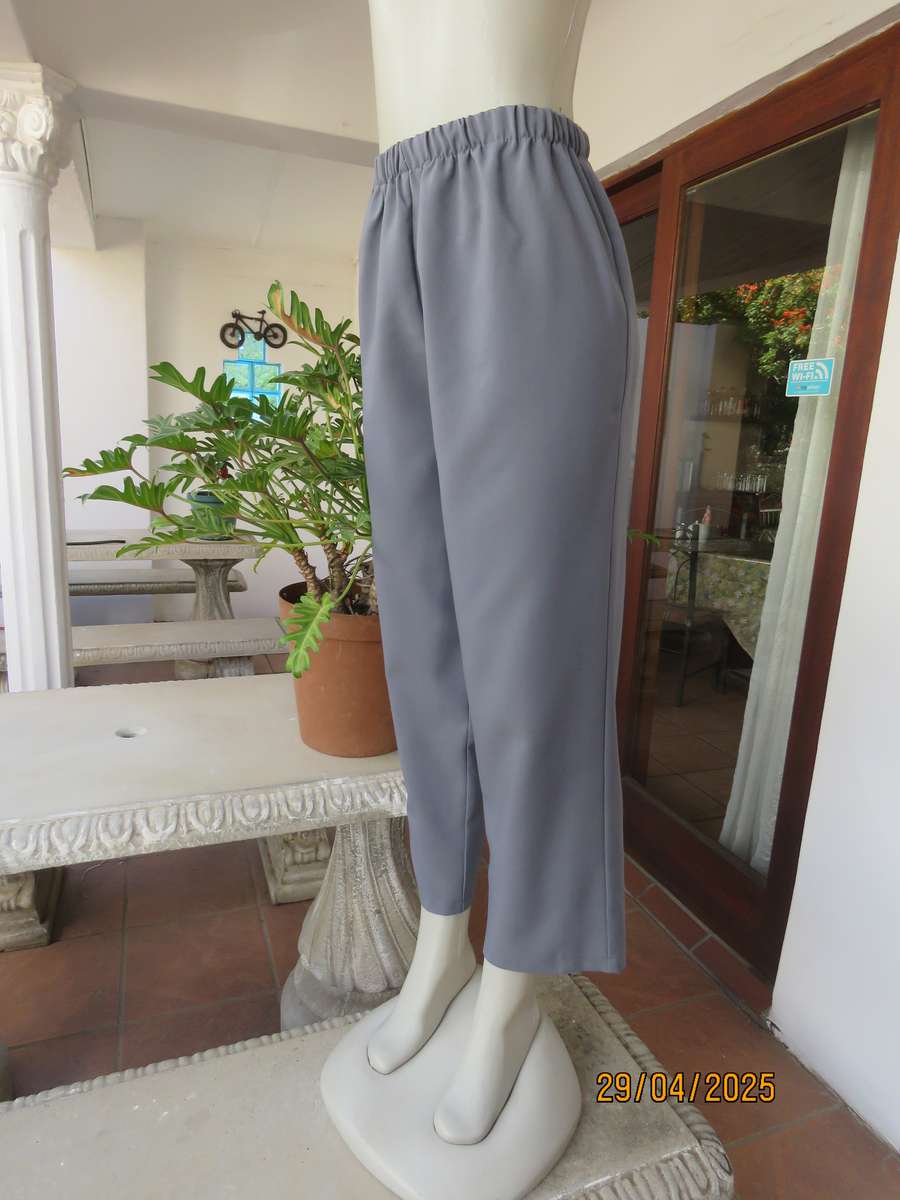 Boutique made hailstorm grey 100% polyester with elasticated waist. Size 40