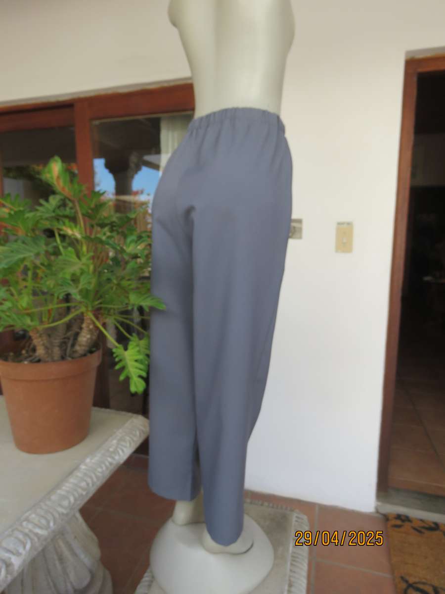 Boutique made hailstorm grey 100% polyester with elasticated waist. Size 40