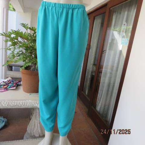 Boutique made aqua colour pants with tapered legs in polyester with elasticated waist. Size 40